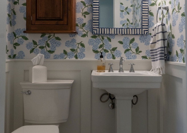 Pedestal sink bathroom with blue flower wallpaper